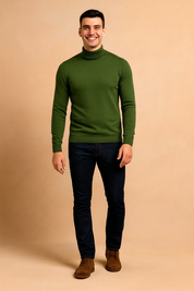 Slim-fit olive green turtleneck sweater with ribbed cuffs and hem, paired with dark indigo jeans and brown suede lace-up shoes.
