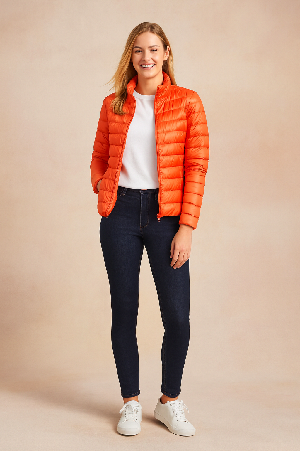 Women's lightweight orange puffer jacket with horizontal quilted design, zip closure, and slim fit cut, styled for casual outdoor wear.