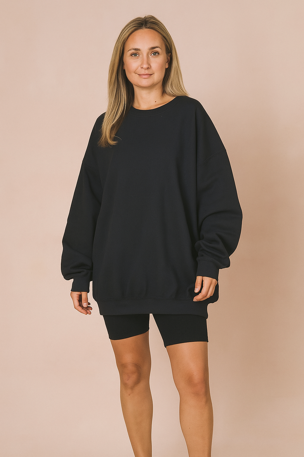 Oversized black crewneck sweatshirt with relaxed fit, featuring drop shoulders and ribbed cuffs, styled for casual or loungewear fashion.