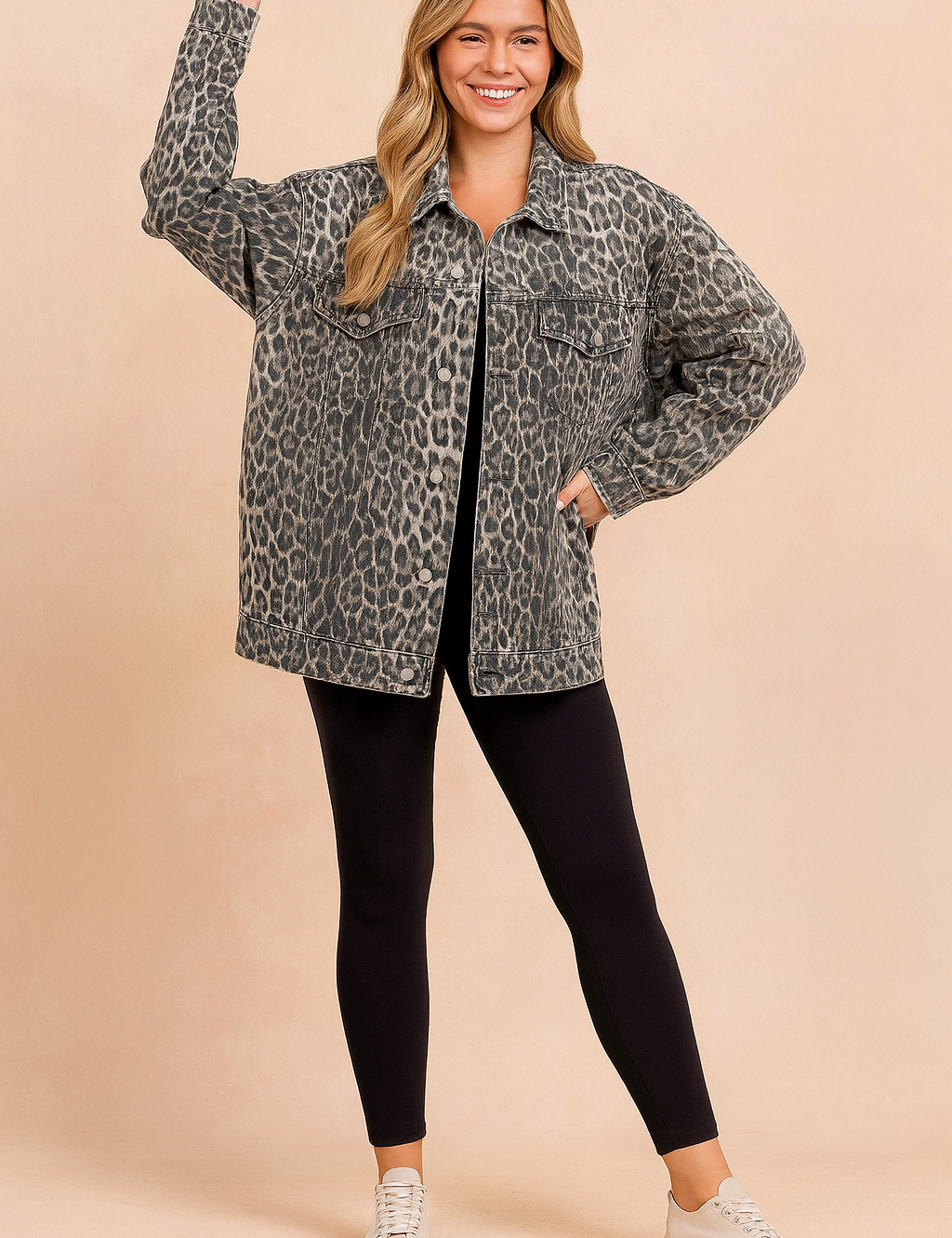 Oversized leopard print denim jacket styled with black leggings and beige sneakers.