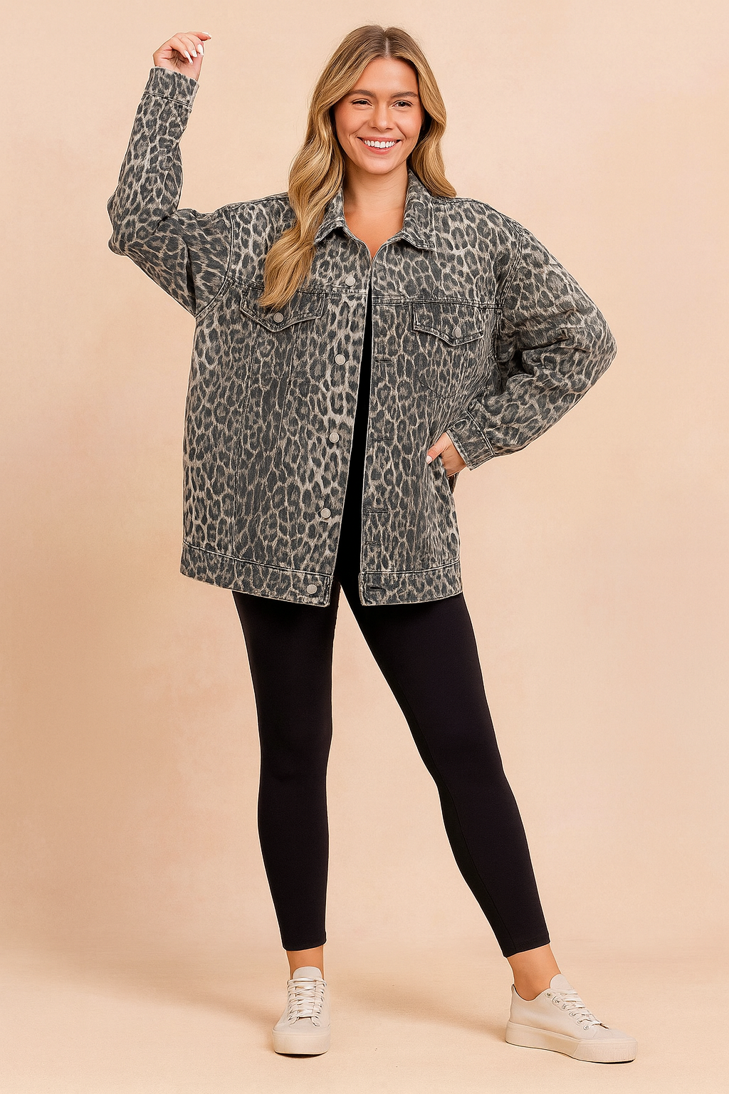 Oversized leopard print denim jacket styled with black leggings and beige sneakers.
