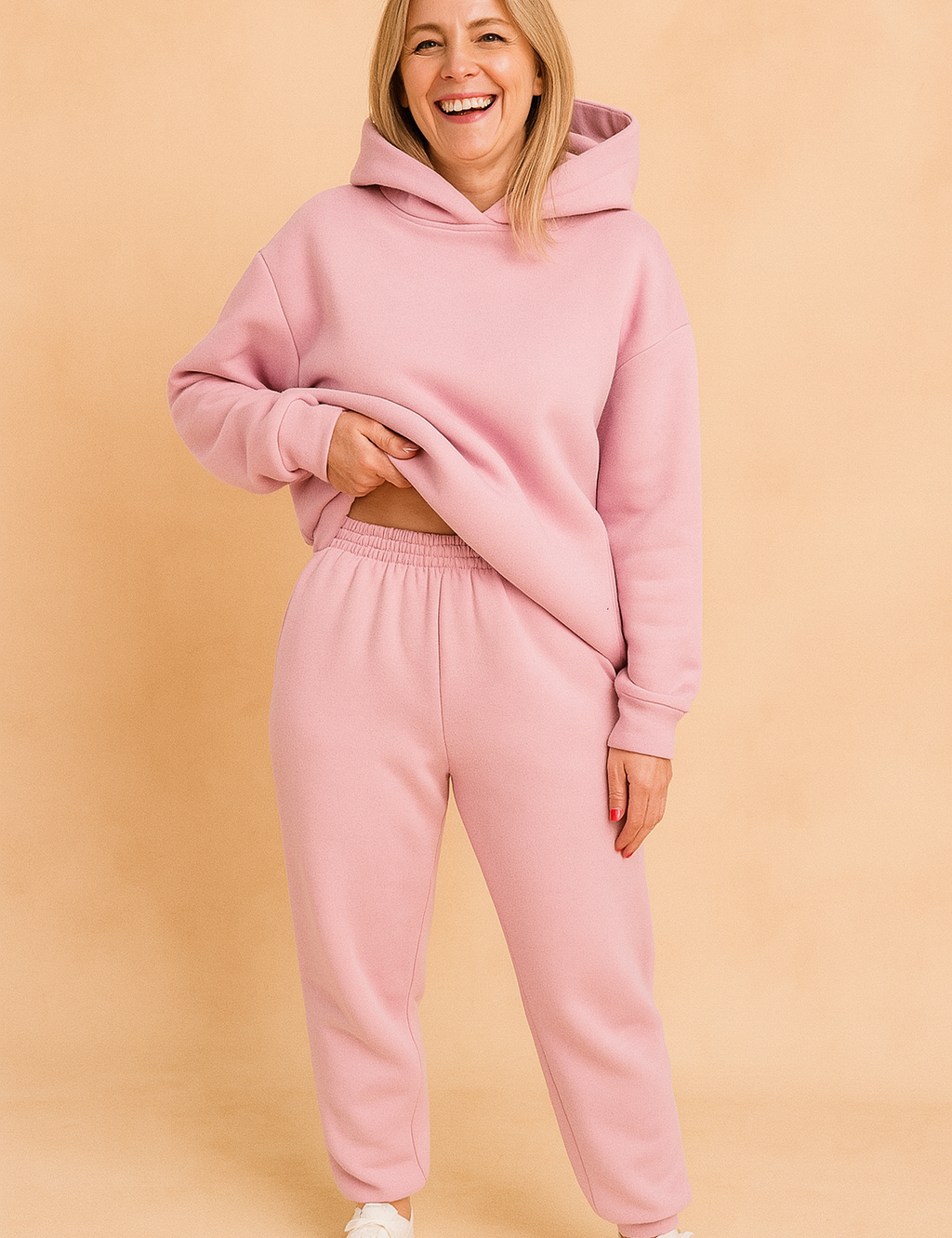 Soft pastel pink matching loungewear set consisting of an oversized hoodie and high-waisted jogger pants with gathered elastic waistband, ideal for casual or home comfort wear.