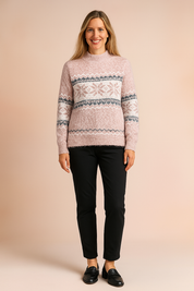 Light pink Fair Isle knit sweater with white and dusty blue snowflake patterns, paired with off-white slim-fit jeans and beige ankle boots.