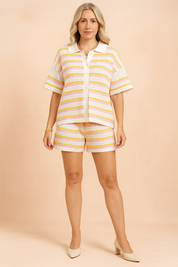 Striped short-sleeve button-up knit top with matching high-waisted shorts, featuring horizontal crochet-style stripes in white, pink, and yellow with a ribbed hem and white trim.