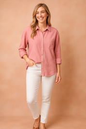 Relaxed-fit dusty pink textured button-up blouse with a chest pocket, collared neckline, and rolled-up sleeves.
