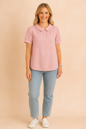 Pastel pink linen blouse with Peter Pan collar and short puff sleeves, styled with light blue jeans and white sneakers