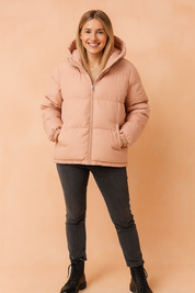 pink unisex puffer jacket with hood, front zipper closure, side pockets, and elastic cuffs, designed for winter warmth and comfort