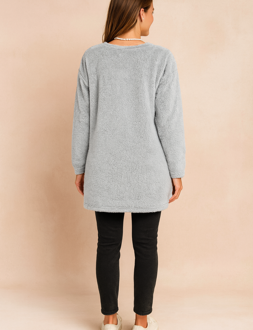 Long oversized sweater with a fluffy, plush texture, featuring two practical front pockets and a simple, comfortable fit.