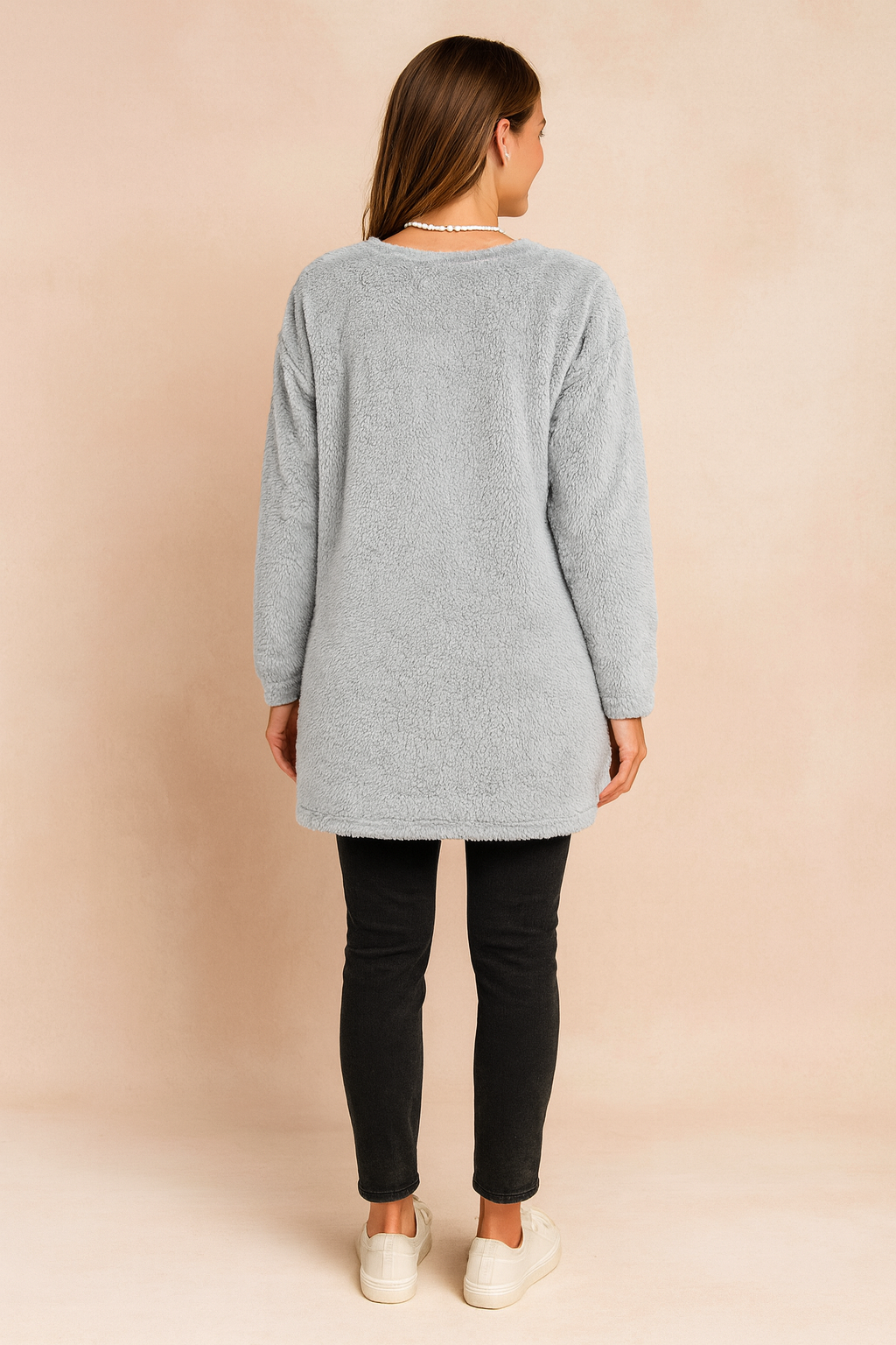 Long oversized sweater with a fluffy, plush texture, featuring two practical front pockets and a simple, comfortable fit.