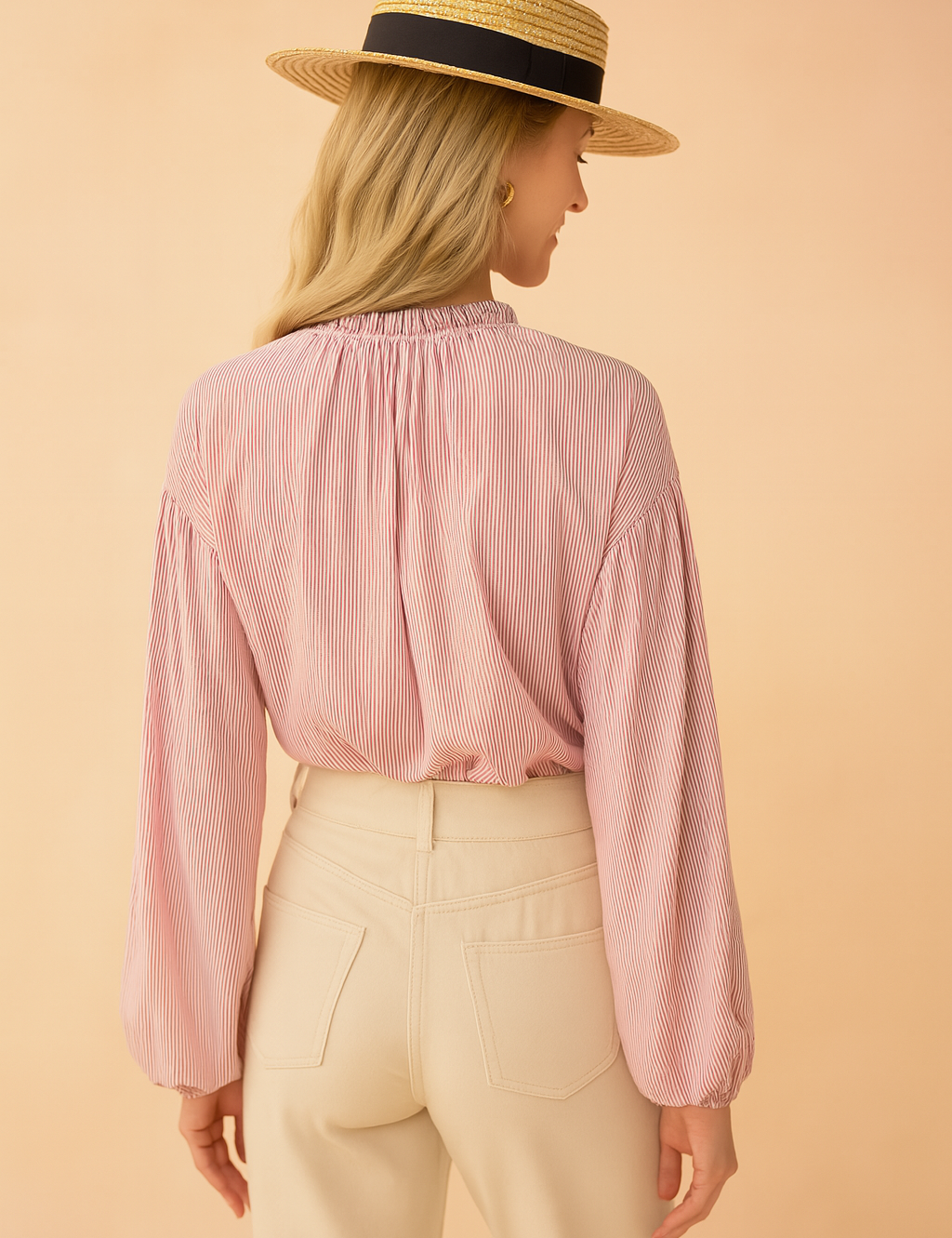 Pink and white pinstriped long-sleeve blouse with gathered neckline paired with high-waisted cream trousers, featuring back pockets and a clean tailored finish.