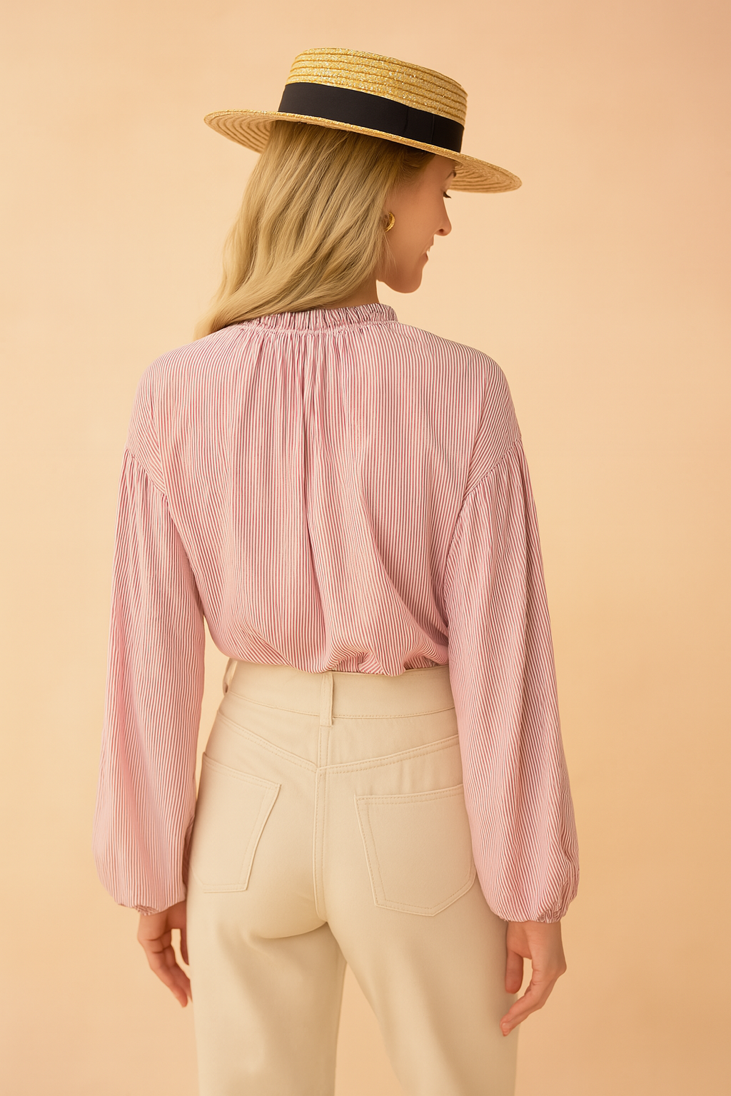 Pink and white pinstriped long-sleeve blouse with gathered neckline paired with high-waisted cream trousers, featuring back pockets and a clean tailored finish.