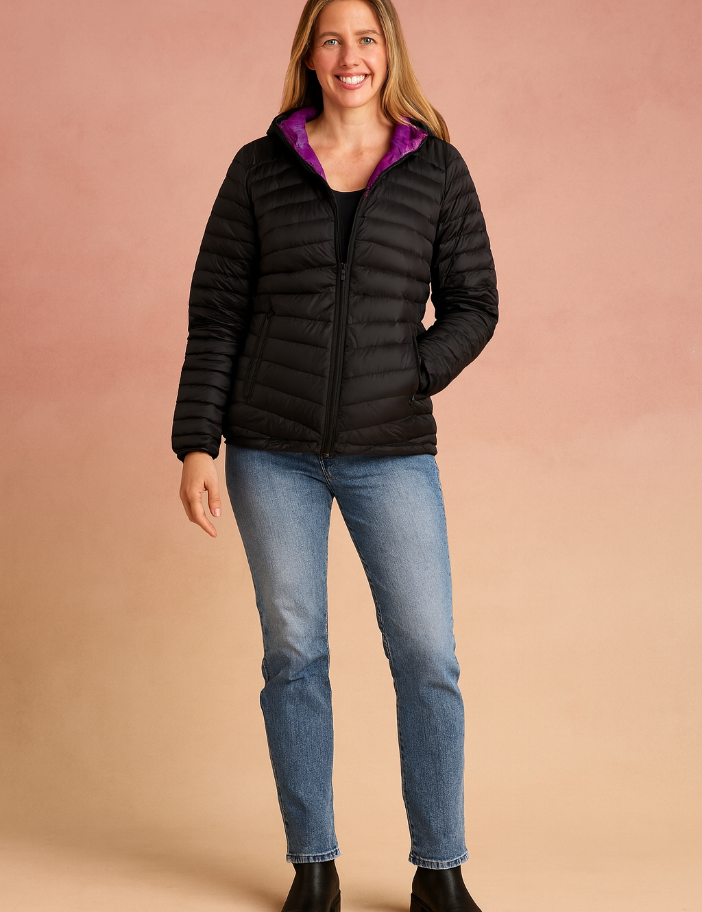  Black quilted puffer jacket with magenta interior lining, featuring a hood, front zipper closure, and two zippered side pockets, paired with light blue straight-leg jeans and black ankle boots.

