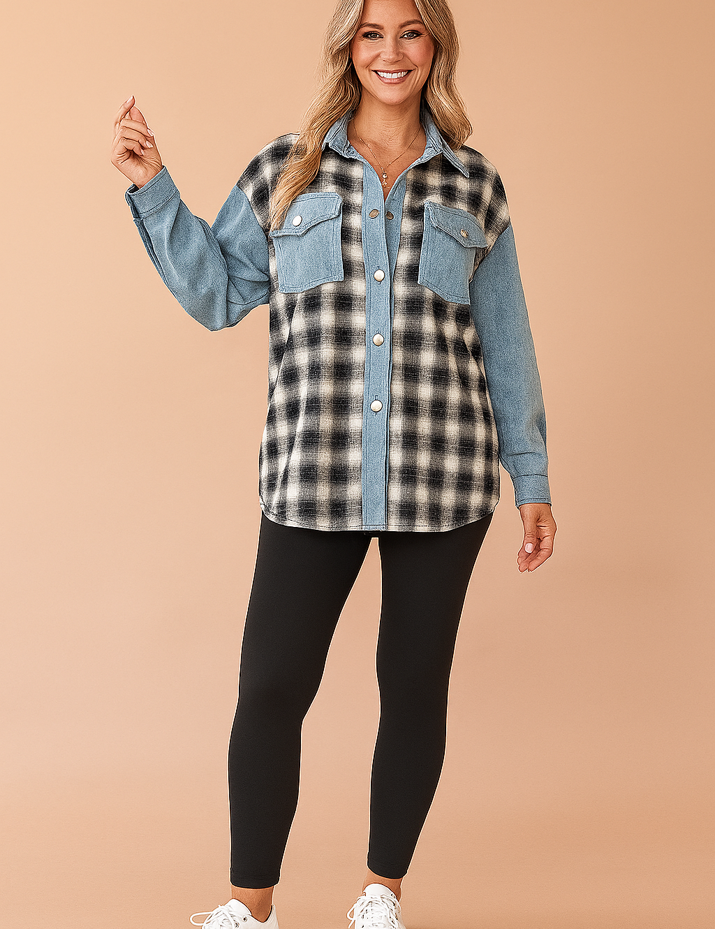 Two-tone oversized shacket with black-and-white plaid flannel on the body and light blue denim on the collar, button placket, chest pockets, and sleeves; worn with high-waisted black leggings and white sneakers.