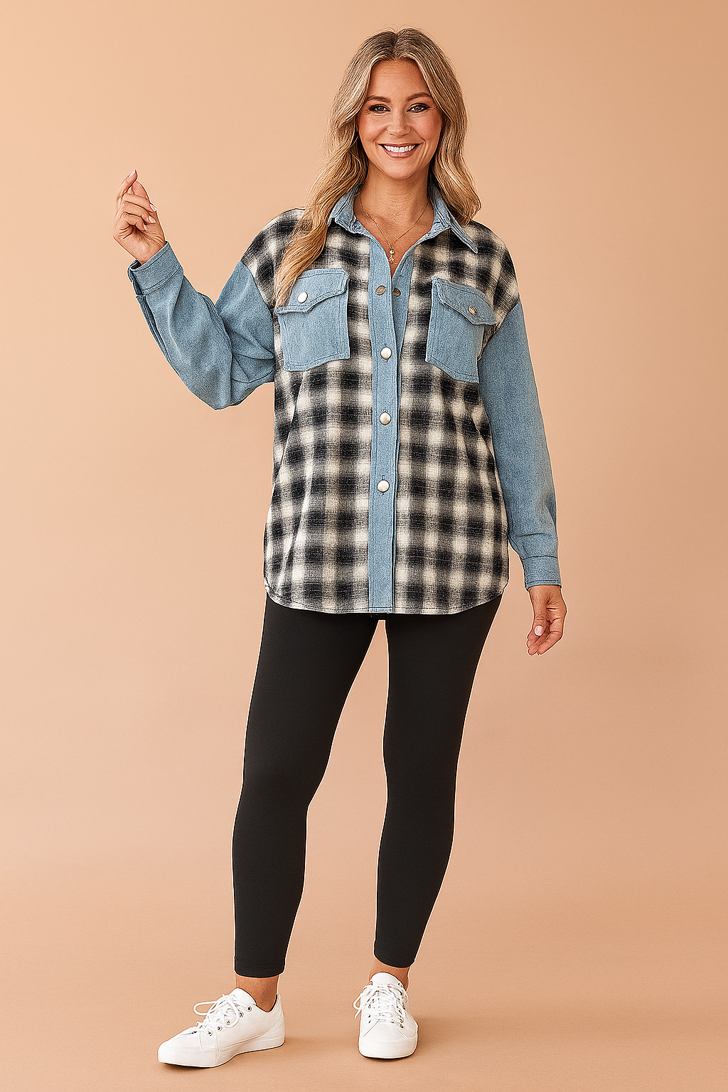 Two-tone oversized shacket with black-and-white plaid flannel on the body and light blue denim on the collar, button placket, chest pockets, and sleeves; worn with high-waisted black leggings and white sneakers.