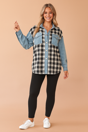 Two-tone oversized shacket with black-and-white plaid flannel on the body and light blue denim on the collar, button placket, chest pockets, and sleeves; worn with high-waisted black leggings and white sneakers.