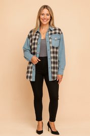 Two-tone oversized button-up shacket combining black-and-white plaid flannel with light blue denim panels, featuring a single front flap pocket, full sleeves, and metal snap buttons, styled over a ribbed gray crop top and paired with high-waisted black skinny jeans.