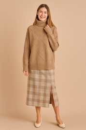 Beige diamond-pattern turtleneck sweater with ribbed texture, long sleeves, and relaxed fit for modern casual wear.