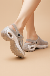 Lightweight gray mesh sandals with breathable perforated uppers, cushioned wave-pattern soles, and supportive heel straps for enhanced comfort and flexibility.