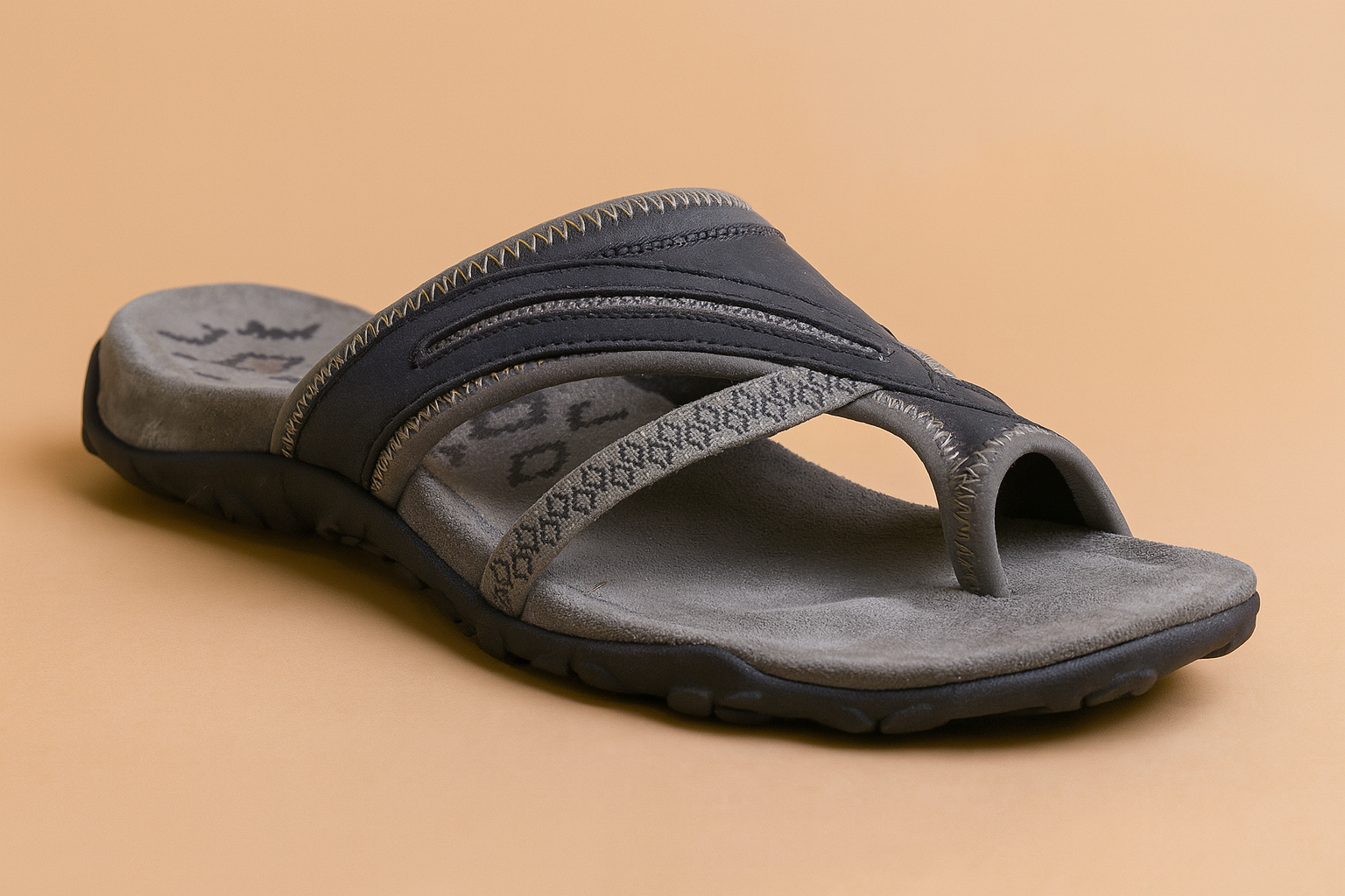 Men’s navy and grey thong sandal with textured suede-like footbed, patterned toe strap, and contrast zigzag stitching on the upper.