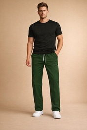 Relaxed-fit men’s green drawstring pants with a clean straight-leg cut, elastic waistband, subtle seam detailing, and minimal branding, styled with low-profile white sneakers for a modern casual look.