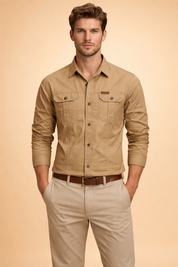 Long-sleeve utility button-up shirt with chest flap pockets, structured seams, and a clean front closure, styled with straight-leg tailored trousers and a classic leather belt