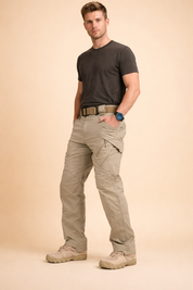 Men’s straight-cut utility cargo pants with structured waistband, reinforced knee panels, angled thigh cargo pockets with flap closure, clean seam detailing, and full-length tapered legs paired with lace-up outdoor shoes.