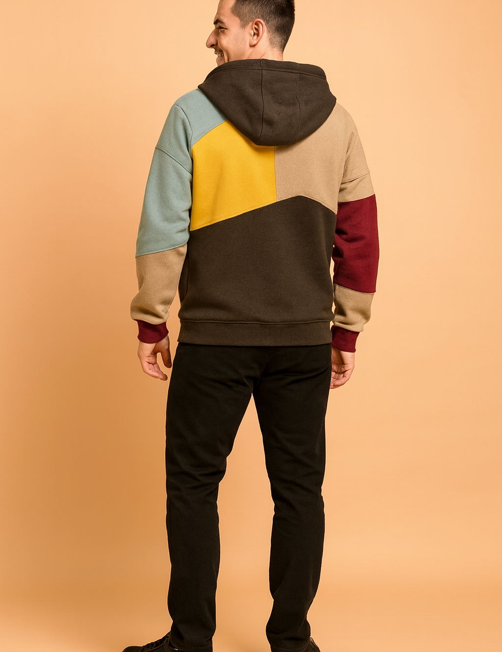 Multicolor patchwork hoodie featuring yellow, beige, light blue, burgundy, and dark brown panels with a relaxed fit and modern streetwear design.
