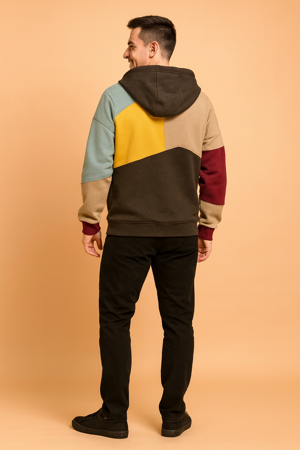 Multicolor patchwork hoodie featuring yellow, beige, light blue, burgundy, and dark brown panels with a relaxed fit and modern streetwear design.