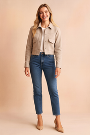 Beige cropped button-up wool jacket with flap pockets, styled with a white tee, blue jeans, and beige pumps.