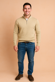 Beige quarter-zip sweater with ribbed cuffs and hem paired with blue jeans and brown suede shoes, styled in a modern casual outfit