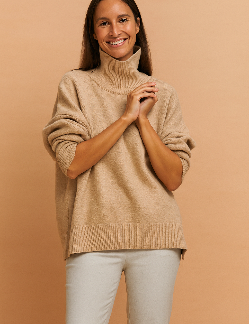 Beige oversized turtleneck sweater with ribbed hem and cuffs, styled with light taupe slim-fit trousers in a cozy neutral-toned ensemble