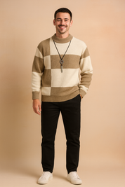 Beige and white block-pattern knit sweater with ribbed cuffs and hem, styled with slim-fit black trousers and white sneakers for a modern smart-casual look.