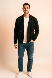 Men’s modern black cardigan with white stitched seam detailing, worn over a plain white shirt, styled with a sleek open front design for casual and semi-formal looks.
