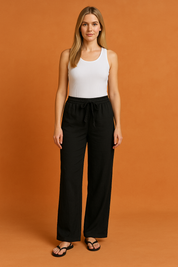 Black wide-leg drawstring pants in a lightweight, flowy fabric with subtle crinkled texture and a relaxed fit, styled for casual summer wear.