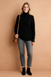 Black diamond-pattern knit turtleneck sweater with ribbed cuffs and hem, styled for a modern chic look.