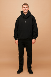 Men’s oversized black hoodie with unique high-neck wrap design, front kangaroo pocket, and embroidered gothic-style letter detail for a bold urban streetwear look.