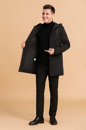 Black hooded long winter coat with quilted inner lining, full front zipper, and sleek modern cut for versatile cold-weather style.