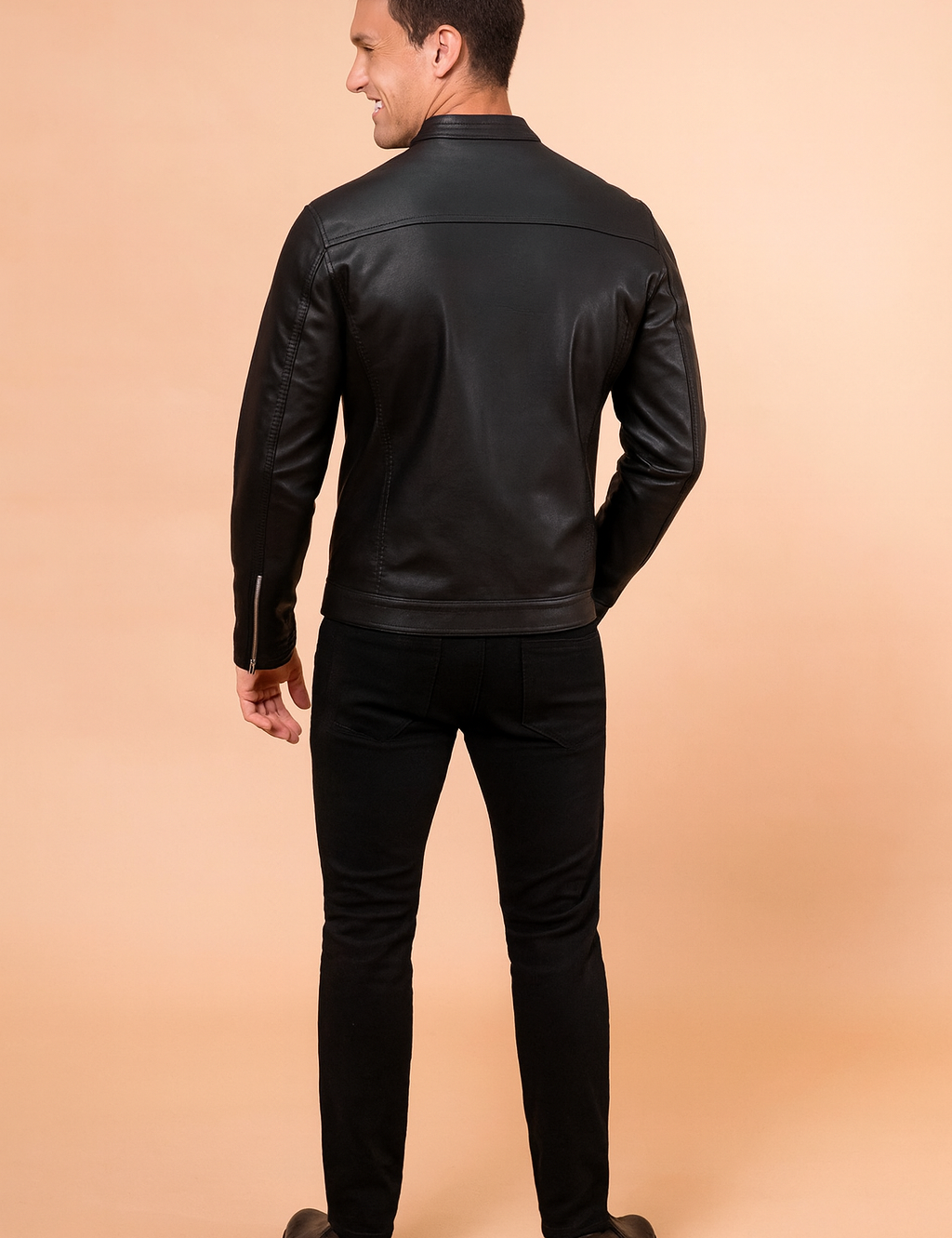 Black leather jacket with a sleek matte finish, rear panel detailing, and clean stitch lines for a modern, stylish fit.