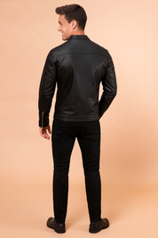 Black leather jacket with a sleek matte finish, rear panel detailing, and clean stitch lines for a modern, stylish fit.