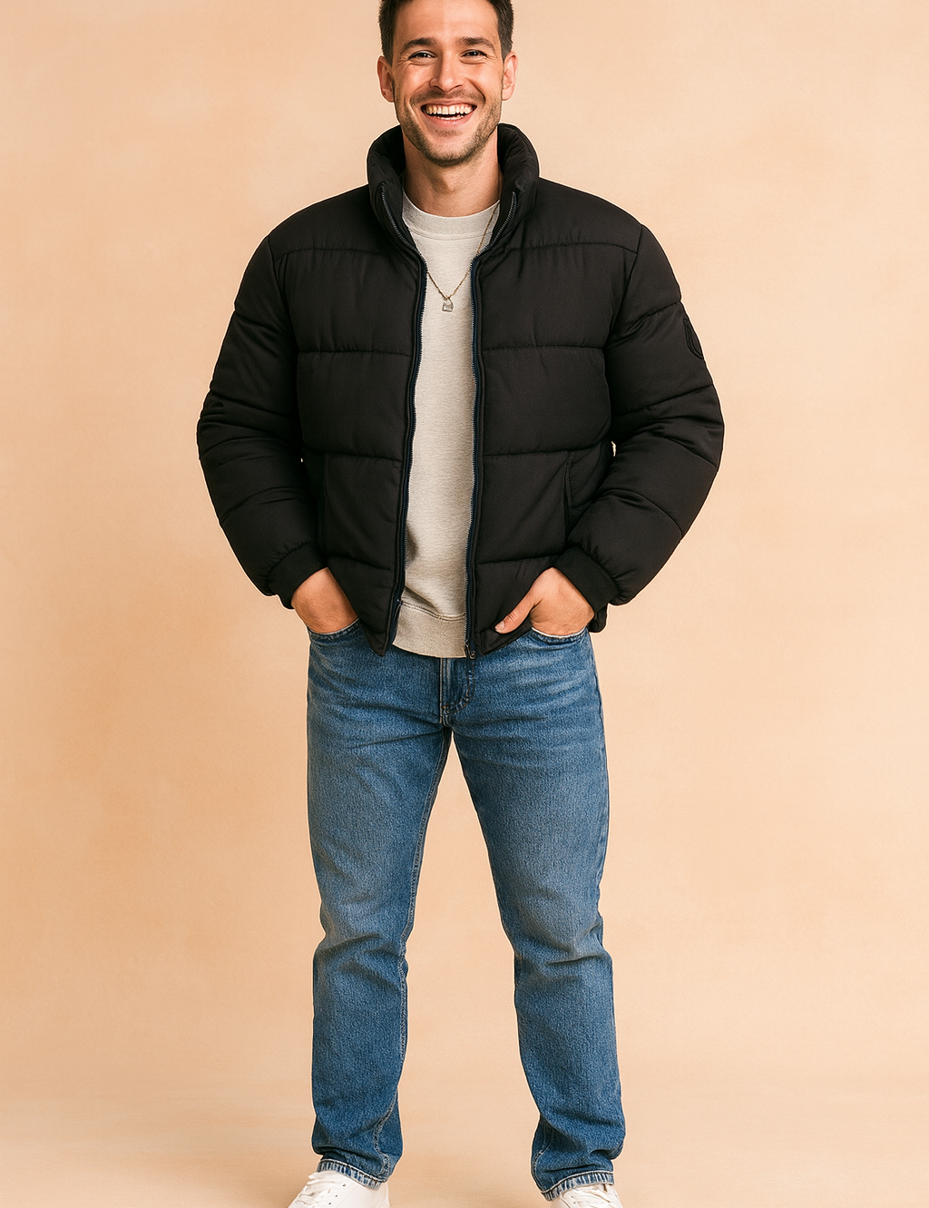 Black puffer jacket with quilted padding, front zip closure, and a high collar, styled casually with a sweatshirt and jeans for a modern winter look.