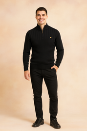 Men’s black ribbed half-zip sweater with subtle vertical knit pattern, paired with slim-fit black pants and matching sneakers for a modern casual look.