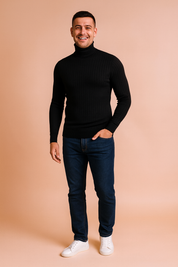 Men’s black ribbed turtleneck sweater with slim fit design, styled with dark wash jeans and white sneakers.