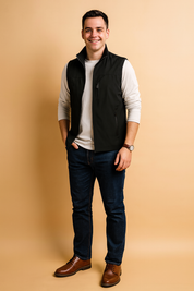 Black sleeveless men's vest with zip closure, multiple pockets, and a sleek casual design, paired with a white long-sleeve shirt and dark jeans for a modern everyday look.
