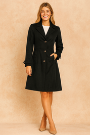 Black tailored coat with notch lapels, button closure, and flap pockets, styled with beige pumps and a white top.