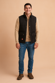 Black padded vest with faux fur lining, snap-button closure, and front flap pockets, styled over a beige sweater with blue jeans for a casual winter-ready outfit.