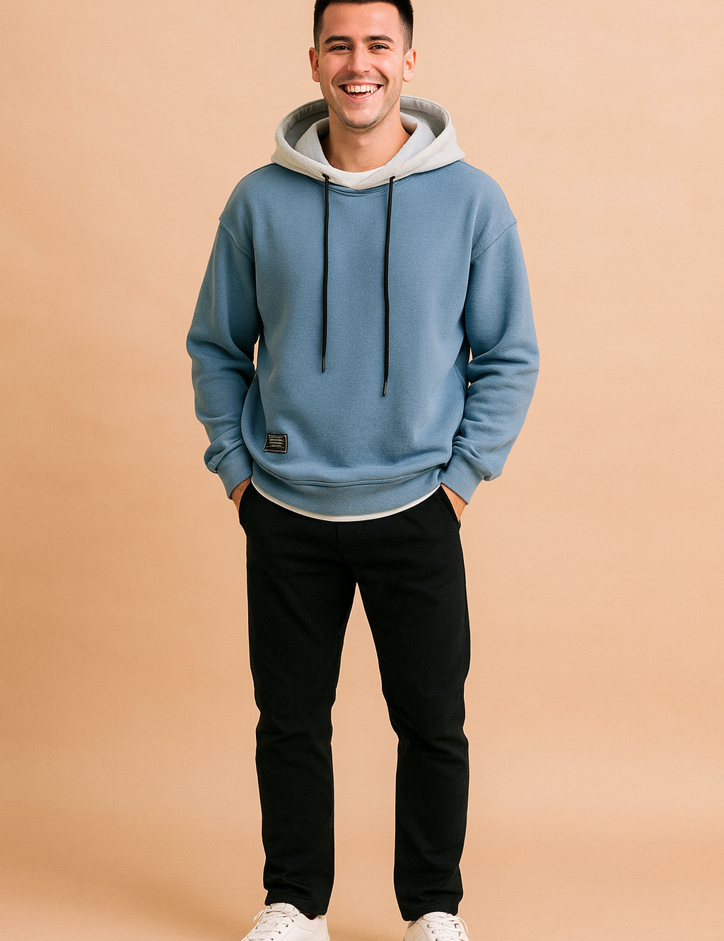 Casual men’s hoodie in soft blue with contrasting light gray hood lining and black drawstrings, styled with ribbed cuffs, hem, and a front patch detail for a modern streetwear look.