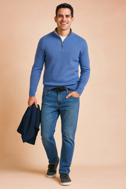Men’s casual blue zip-neck sweater with ribbed cuffs and hem, paired with straight-fit blue jeans and dark grey sneakers, designed for a modern and comfortable everyday style.