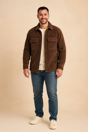 Brown corduroy sherpa-lined jacket with front button closure, chest flap pockets, and straight hem, styled with a cream T-shirt, jeans, and sneakers for a casual look.