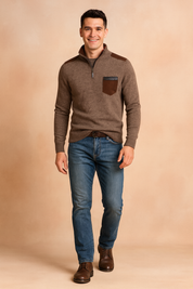 Men's brown knit pullover sweater with half-zip collar, contrasting shoulder accents, and chest pocket, styled with blue jeans and brown leather boots for a casual yet refined look