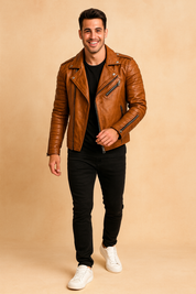 Brown quilted leather biker jacket with asymmetrical zipper closure, quilted sleeves, and metallic snap details, styled with a black T-shirt, slim-fit jeans, and sneakers.